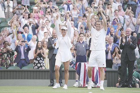 ◎ 當日時間七月七日,在倫敦溫布頓網球錦標賽的混雙決賽中,英國的尼爾.斯庫普斯基和美國的德西雷.珂拉芙琪珂在混雙決賽中擊敗澳大利亞的馬修.埃布登和澳大利亞的薩曼莎.斯托瑟後,慶祝他們奪的獎盃。(美聯社)