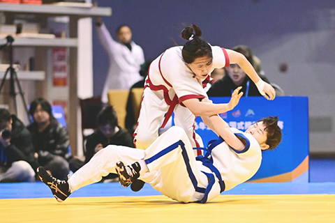 ◎ 三月二十四日,黑龍江省隊選手高宇飛(上)與首都體育學院隊選手丁藝在女子六十公斤級決賽中。最終,高宇飛戰勝丁藝,奪得冠軍。全國中國式摔跤錦標賽在四川省峨眉山市落幕。(新華社發 周小軍 攝)